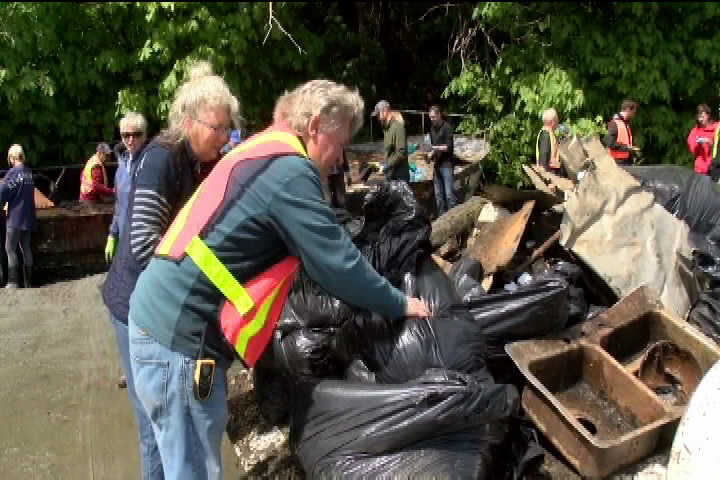 Volunteers clean Cadboro Bay beach but derelict boats remain after funding issue