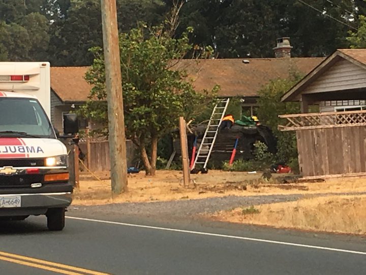 Two people rescued after car flips onto side in Colwood home's front yard