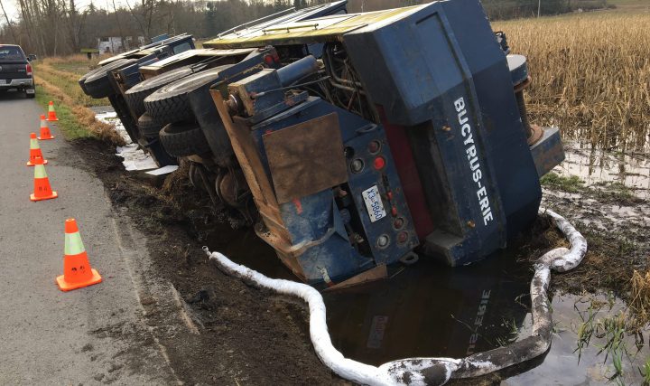 Booms, mats laid to contain oil spill on Lochside in Central Saanich crane truck rollover