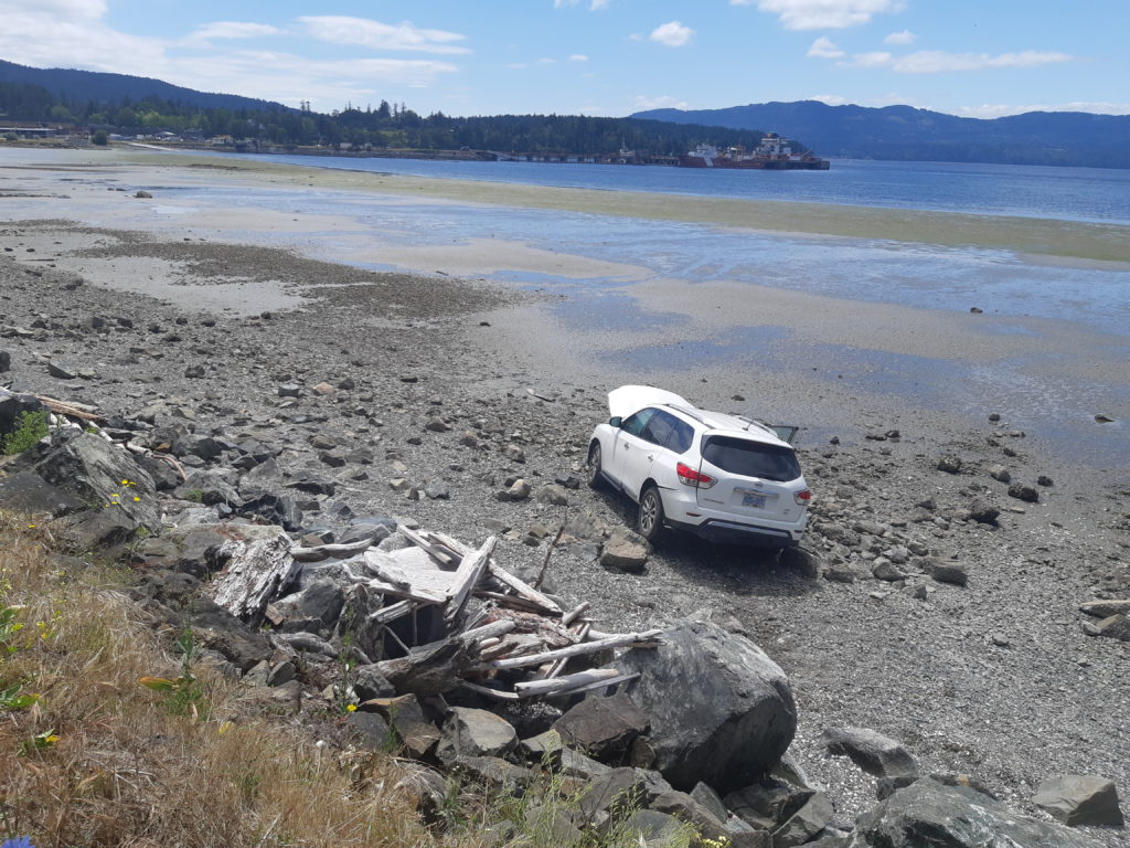 SUV veers off West Saanich Road, ends up on nearby beach (PICS)