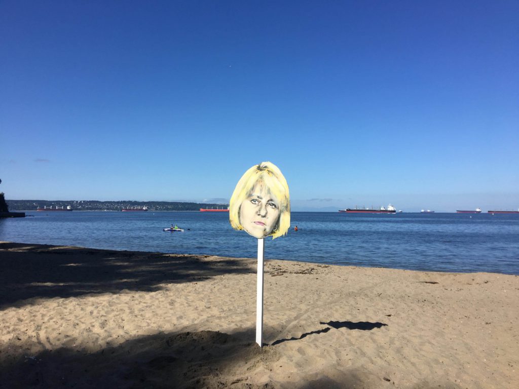 Stencil of Dr. Bonnie Henry's face overlooks Third Beach in Vancouver after large gathering