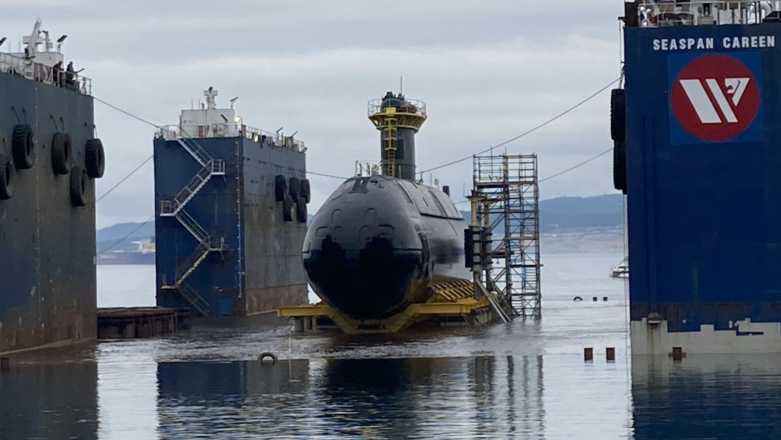 HMCS Corner Brook barged to Ogden Point as it prepares to return to the