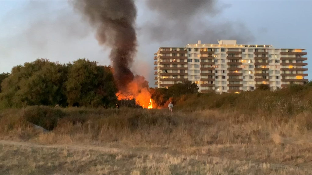 Fire breaks out in dry brush near encampment along Dallas Road