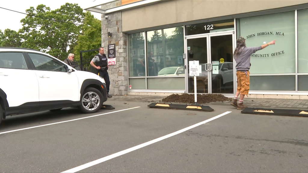 Old-growth protesters dump manure in front of Horgan's constituency office