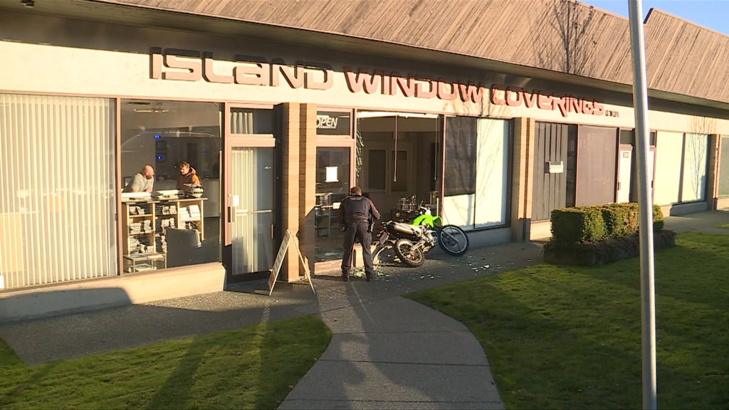 Motorcyclist suffers minor injury after bike crashes through Saanich business